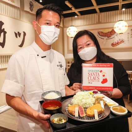 Chef Chan Tze-yeung and Café Deco Group director of sales and marketing Catherine Yuen show off a meal at Kyoto Katsugyu in Causeway Bay that raises money for Operation Santa Claus. Photo: Nora Tam