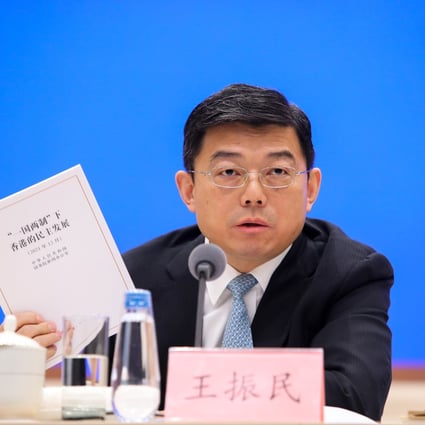 Tsinghua University law professor Wang Zhenmin with a copy of the white paper at the briefing on Beijing’s recent white paper on Hong Kong’s democratic development. Photo: Simon Song