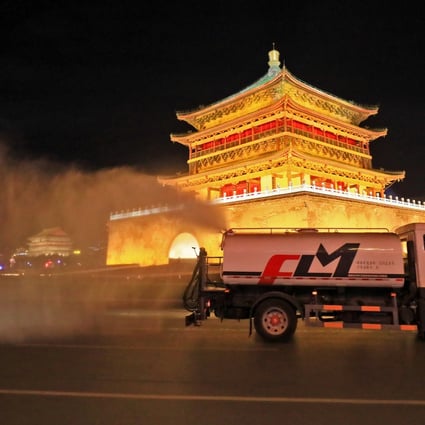 A disinfection vehicle at work on Sunday night near the Xian Bell Tower, as officials in the northwestern Chinese city battle a Covid-19 outbreak. Photo: Getty Images