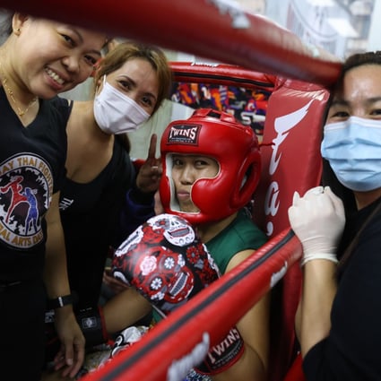 Amateur fighter Jenalyn Abraham with her support crew at the Muay Thai Fighters Club tournament. Photo: Nora Tam   