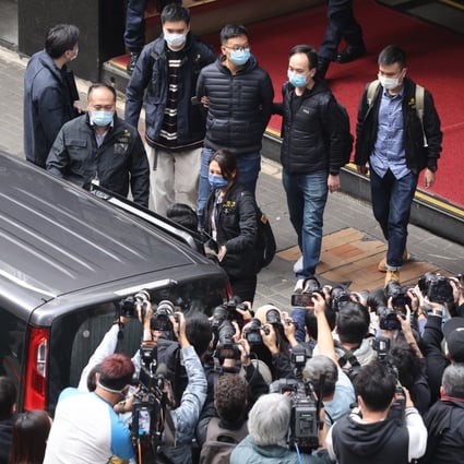 National security police escort Stand News acting editor-in-chief Patrick Lam from the outlet’s Kwun Tong office in handcuffs. Photo: May Tse