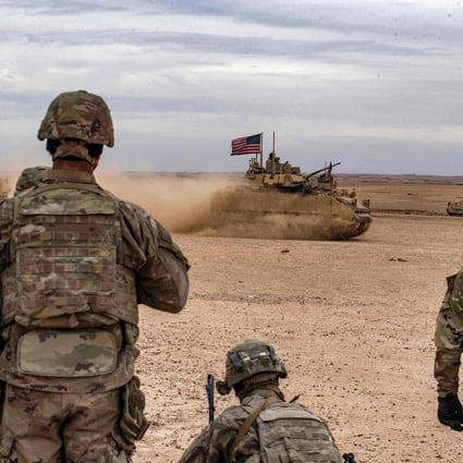 US soldiers watch an armoured vehicle flying an American flag during a joint military exercise with allied forces in Syria earlier this month. Photo: AFP