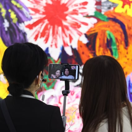 Visitors live-stream while attending Art Basel Hong Kong 2021 at the Hong Kong Convention and Exhibition Centre in Wan Chai on May 19. Photo: Nora Tam