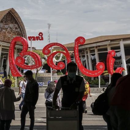 Domestic tourists at Bali’s international airport. They have flocked to the island in December, and the island is busier than at any time during the pandemic. Photo: Anadolu Agency via Getty Images