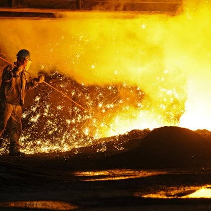 An employee works next to molten iron at a steel mill of Dongbei Special Steel in Dalian in Liaoning province on July 17, 2018. Photo: Reuters.