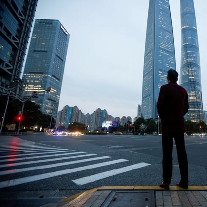 A man stands at a crossroads in Lujiazui financial district in Shanghai in March 2021. Photo: Reuters
