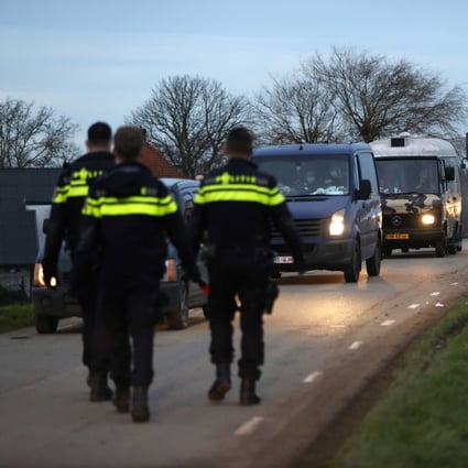 Police officers check cars leaving the site of a brick factory in Rijswijk, Netherlands, where an illegal party was held on New Year’s Day. Photo:  EPA-EFE