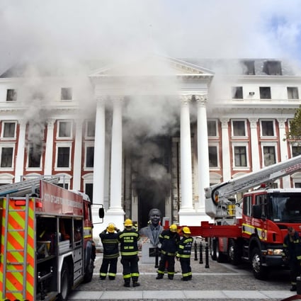 Firefighters work after a fire broke out in the parliament in Cape Town, South Africa on January 2. Photo: Elmond Jiyane / GCIS / Handout via Reuters