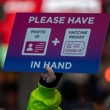 A person holds a sign at a checkpoint as revellers gather ahead of New Year’s Eve celebrations in New York’s Times Square on December 31. Despite record numbers of Covid-19 cases across the city and nationwide, the celebrations went ahead. Photo: Getty Images / AFP