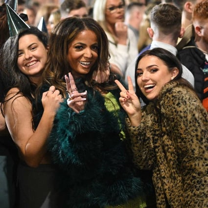 Revellers pose for a photo as they queue to enter a 10,000 capacity nightclub in Manchester, England on New Year’s Eve, 2021. England was the exception among the four UK nations in not imposing extra virus curbs over the festive period. Britain’s Prime Minister Boris Johnson urged people to get tested and be “sensible”. Photo: AFP