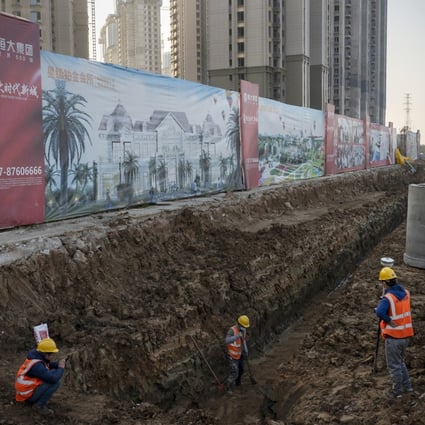 Workers at a construction site of a China Evergrande Group development in Wuhan, on December 22. The developer has more than US$300 billion of debts and is scrambling to raise cash. Photo: Bloomberg