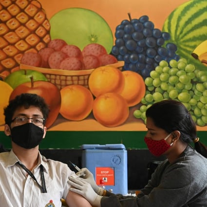 A health worker inoculates a student  in Kolkata. Photo: AFP