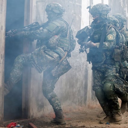 Taiwanese soldiers take part in the drill in a mock-up town in Kaohsiung on Thursday. Photo: Bloomberg