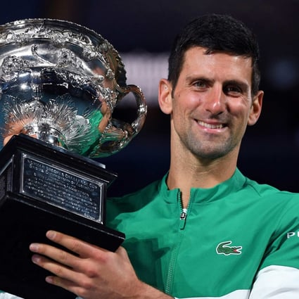 Serbia’s Novak Djokovic poses with the Norman Brookes Challenge Cup trophy following his victory against Russia’s Daniil Medvedev in their men’s singles final match on day fourteen of the 2021 Australian Open. Photo: AFP