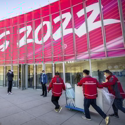 Workers deliver equipment to the Olympic Village in Beijing. Photo: AP