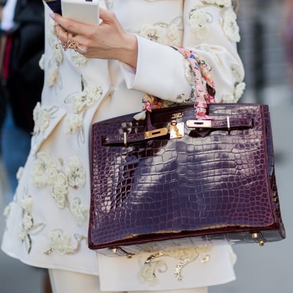 A Paris fashion week guest carries an Hermès bag. Like that luxury house, Chanel has begun limiting customer purchases to maintain exclusivity and drive demand. Photo: Getty Images