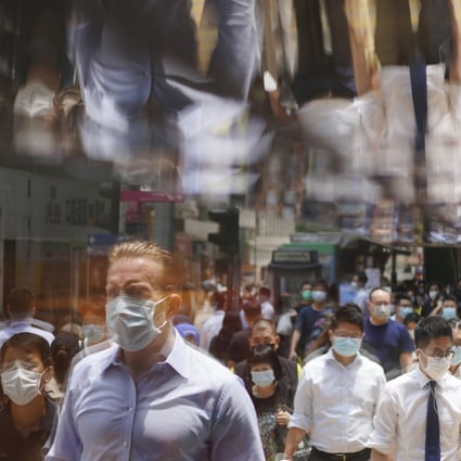Pedestrians cross the street during lunch time in Central, Hong Kong. Photo: Sam Tsang