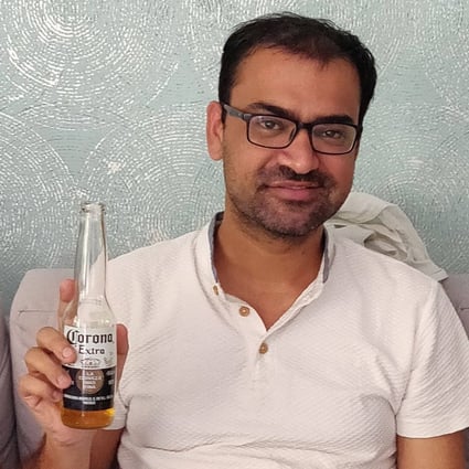 Kovid Kapoor poses for a picture while drinking a Corona beer in Mumbai. Photo: Handout via AFP