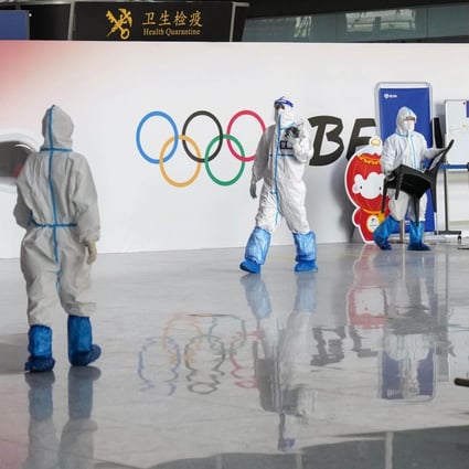 Officials wearing protective gear work at Beijing Capital International Airport on Jan 4, 2022, amid concerns over the novel coronavirus ahead of the Beijing Winter Olympics. Photo:
Kyodo