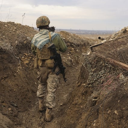 A Ukrainian soldier holding a cat walks in a trench on the line of separation from pro-Russian rebels in the Donetsk region of Ukraine. With the fate of Ukraine and potentially broader post-Cold War European stability at stake, the US and Russia are due to start critical talks that could shape the future of their bilateral ties and the relationship between the US and its Nato allies. Photo: AP