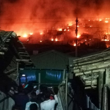 Smoke and flames seen on a hillside after a fire broke out in a Rohingya refugee camp in Bangladesh on Sunday. Thousands of people were left homeless after the blaze gutted parts of the camp, police said. Photo: AFP