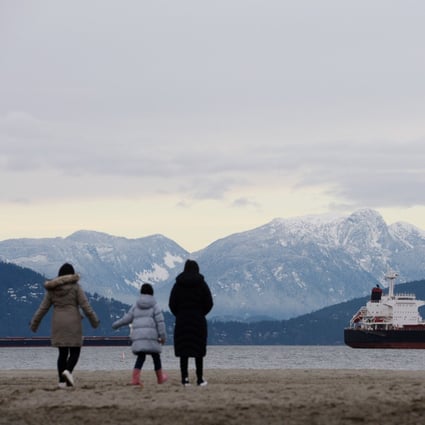 A woman who emigrated from Hong Kong walks along Jericho Beach with her daughters in Vancouver, British Columbia, in 2021. Photo: Reuters 