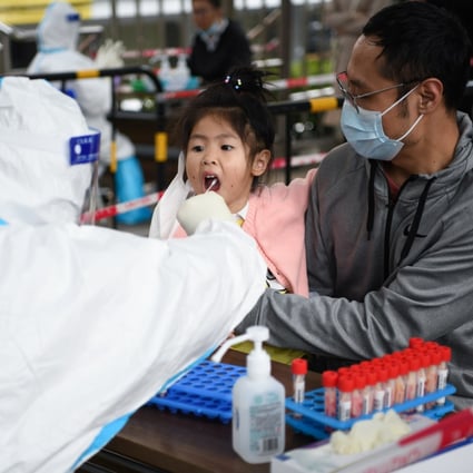 A child gets tested for Covid-19 in Shenzhen’s Futian district on Sunday. Compulsory testing is under way in the city of 12.5 million. Photo: Xinhua