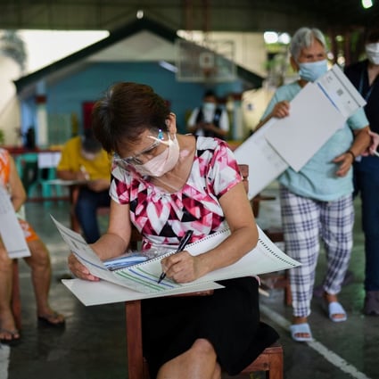 People pretend to cast their votes for the 2022 Philippine presidential election during a simulation exercise in Metro Manila last month. Photo: Reuters