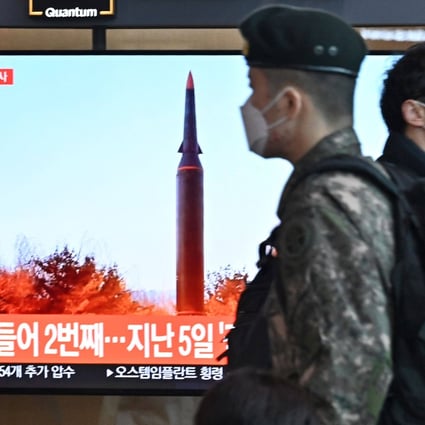People walk past a television showing a file image of a North Korean missile launch at Seoul Railway Station in South Korea on Tuesday. Photo: AFP