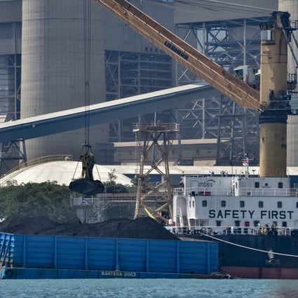 Coal is unloaded from a barge at the Suralaya coal power plant in Cilegon, Indonesia, in September. Photo: AFP