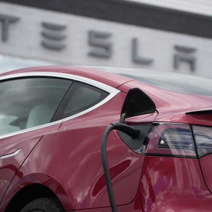 A Model 3 car charges at a Tesla dealership in the United States. Photo: AP