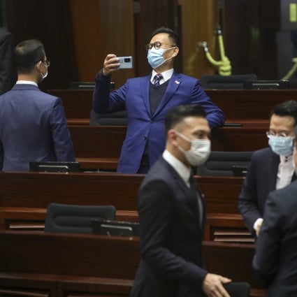 Lawmaker Chan Han-pan (centre) takes a photo after the question and answer session at the Legislative Council on Wednesday. Photo: Sam Tsang