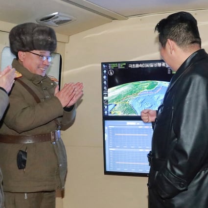 North Korean leader Kim Jong-un (right) speaks with officials during what state media reported as a hypersonic missile test at an undisclosed location in North Korea on Tuesday. Photo: KCNA via Reuters