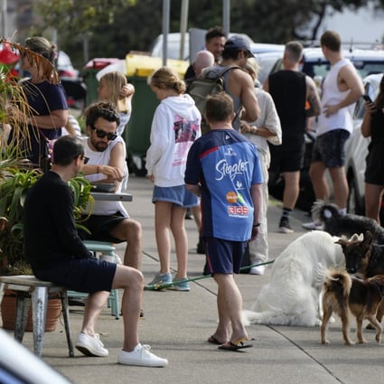 Customers wait outside a cafe at Bondi Beach in Sydney, Australia. Photo: AP