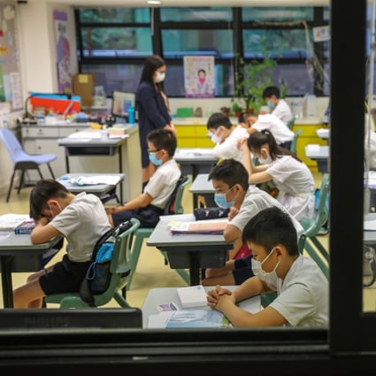 Students and teachers of S.K.H. St. James’ Primary School in Wan Chai pray for the easing of the coronavirus situation in Hong Kong on June 8, 2020. Photo: Nora Tam