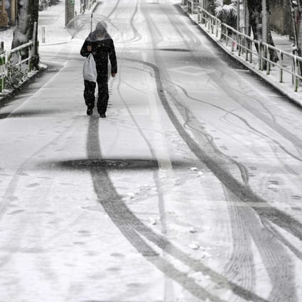 An elderly man walks along a street covered with snow in Tokyo. A growing trend of elder abuse in Japan has raised concerns for the rest of ageing Asia. Photo: EPA