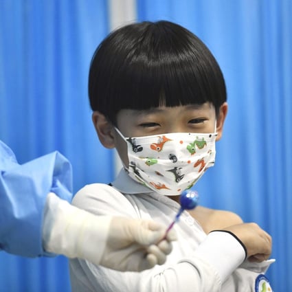 A boy gets a lollipop from a medical worker after receiving a dose of Covid-19 vaccine in Tianjin, China. Photo: Xinhua