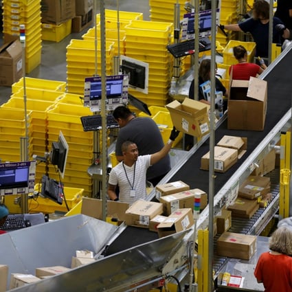 Workers sort arriving products at an Amazon Fulfilment Centre. Photo: Reuters 


