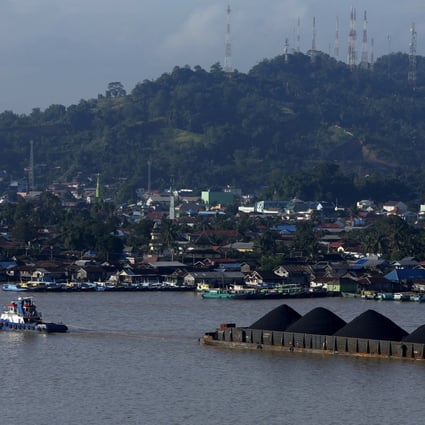 A tug boat pulls a coal barge in Indonesia. Photo: Reuters