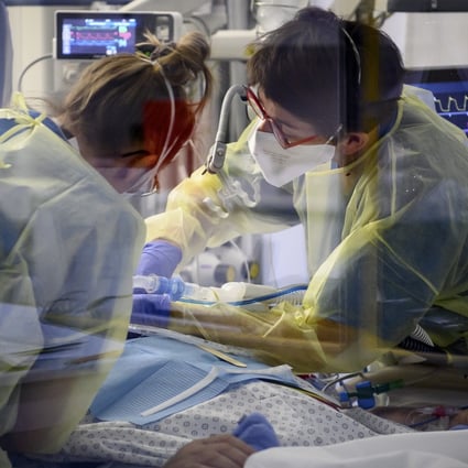 Medical workers treat a patient with Covid-19 in the intensive care unit of a hospital in Neuchatel, Switzerland in December. Photo: Keystone via AP