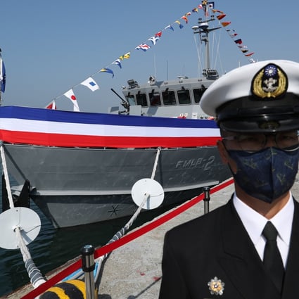 A Taiwan navy officer stands guard in front of a domestically produced mine-laying ship during an inauguration ceremony at a naval base in Kaohsiung, Taiwan, on Friday. Photo: EPA-EFE