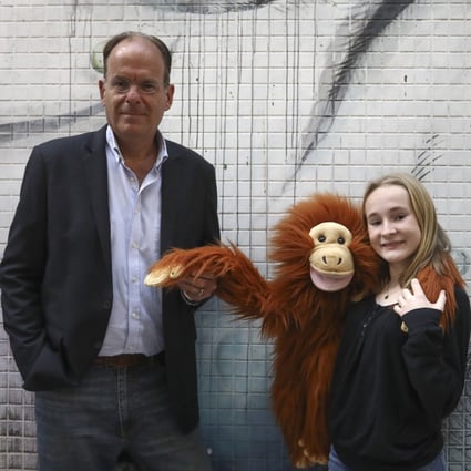 EcoMatcher CEO Bas Fransen (left) with 13-year-old Elodie Lambotte and her orangutan puppet Jack. The teen is calling on companies to protect the environment. Photo: Jonathan Wong