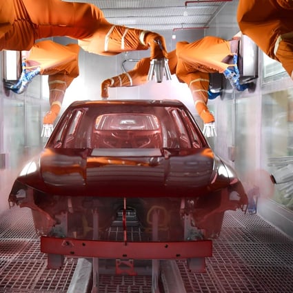 Robotic arms paint a car at the BYD’s Xian plant in Shaanxi province. Photo:  China Daily via Reuters