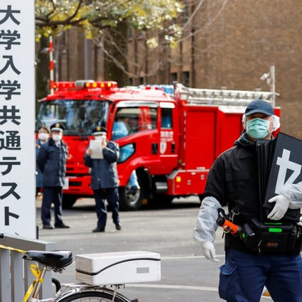 Police officers inspect the site of the stabbing incident in Tokyo on Saturday. Photo: Reuters