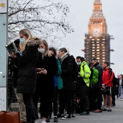 People queue at Westminster Bridge to receive Covid-19 vaccine and booster doses. Photo: Reuters