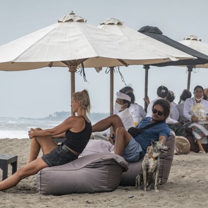 Tourists sit at a beach in Canggu, Indonesia’s Bali. Photo: EPA-EFE