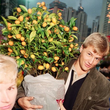 An expatriate purchases a miniature tangerine tree for Lunar New Year at the Flower Market in Victoria Park, Causeway Bay, in 1996. This and giving lai see is still the extent of many foreigners’ involvement in the festival. Photo: SCMP