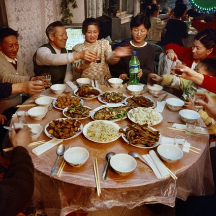 A family celebrate the Lunar New Year in Heihe, China, in 1999. Recipes for dishes for festivals like this are recreated in Chinese Feasts & Festivals – A Cookbook. Photo: Getty Images