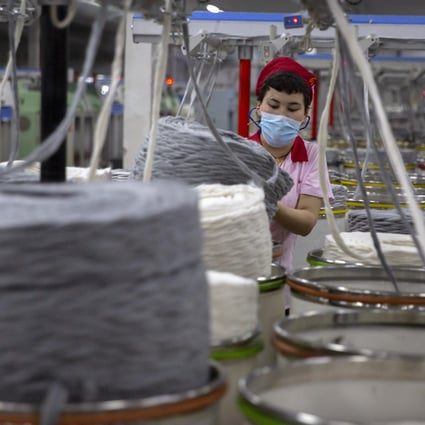 A worker gathers cotton yarn at a textile manufacturing plant in the Xinjiang region of China, where human rights abuses are suspected. Photo: AP