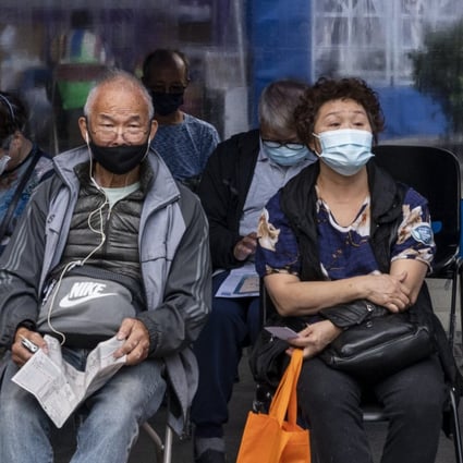 Residents wait at a rest area after receiving a vaccine at a mobile vaccination station in Hong Kong. Photo: Anadolu Agency via Getty Images